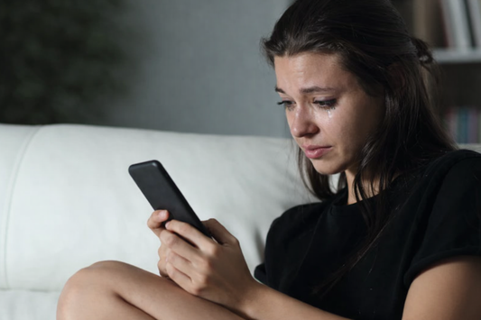 sad teeenaEmotional moment with phone in handge girl sending a breakup message