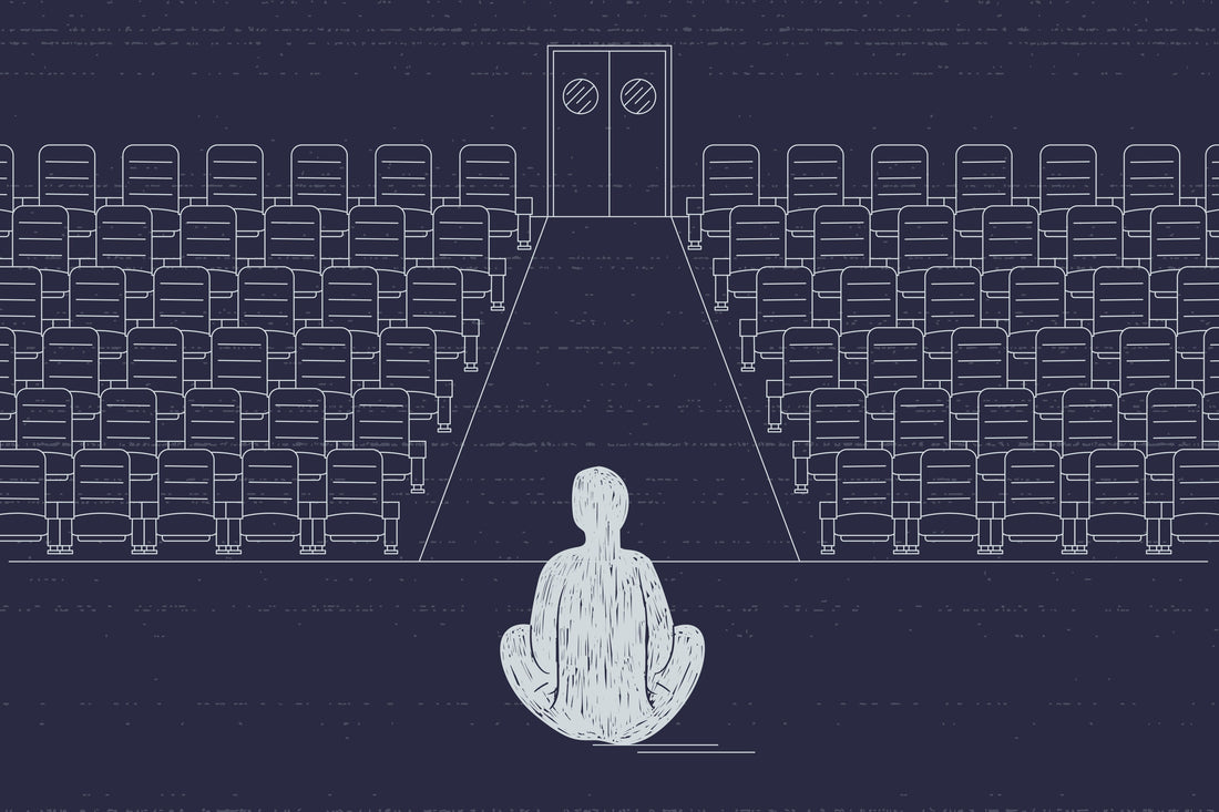 solitary man in an empty movie theatre symbolizing panic of being alone after breakup