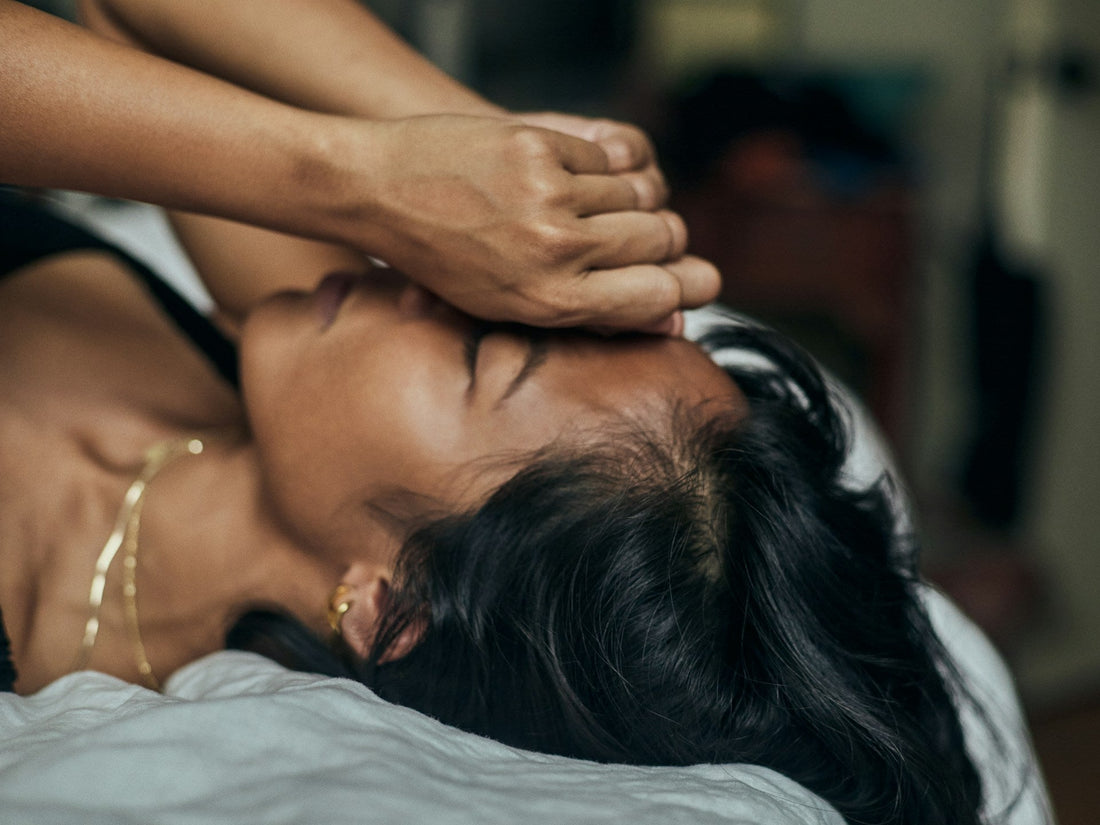 african american woman lying in bed holding her head clearly confused and distressed about having doubts in her relationship