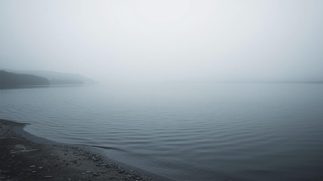 Calm lake surface shifting from stillness to gentle ripples, symbolizing emotional shutdown followed by sudden overwhelm.