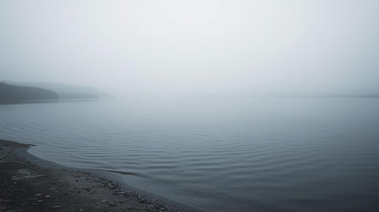 Calm lake surface shifting from stillness to gentle ripples, symbolizing emotional shutdown followed by sudden overwhelm.
