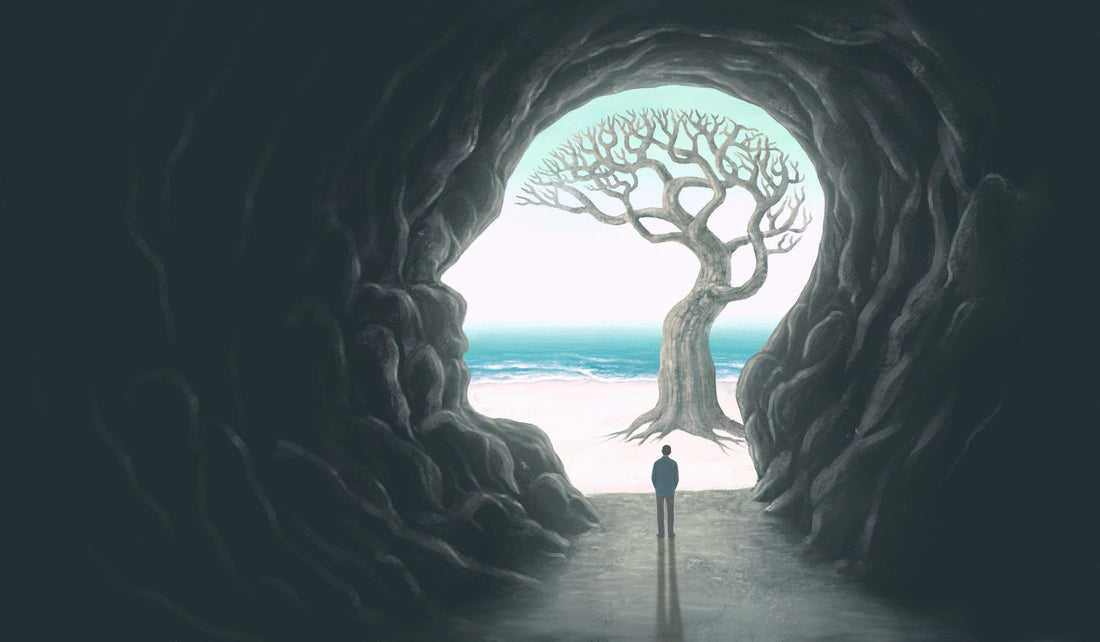 dreamy image of man in a cave walking towards light symbolizing Why Am I Fantasizing About Being Single