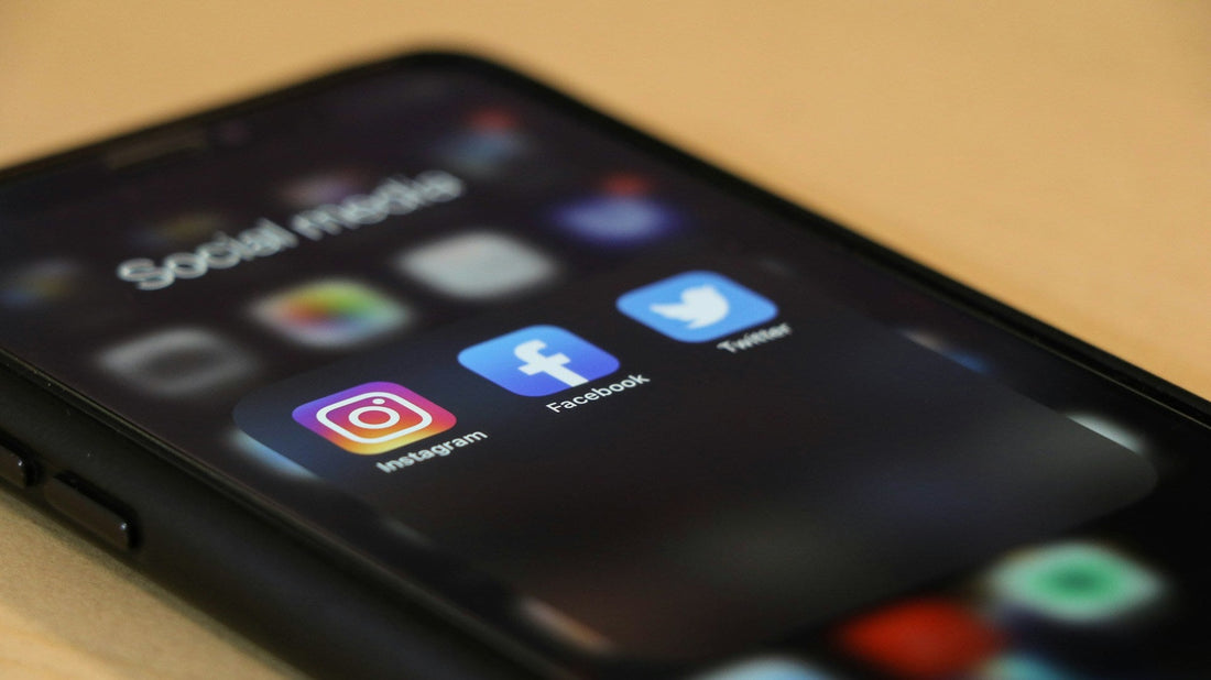 mobile phone with social media icons symbolizing Why Social Media Makes Breakup Jealousy Worse