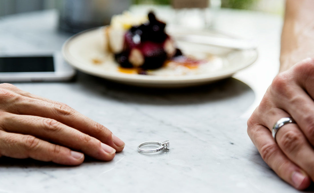 Close-up of a couple’s hands with a wedding ring placed between them, illustrating ADHD divorce statistics, marriage strain, and relationship breakdown.