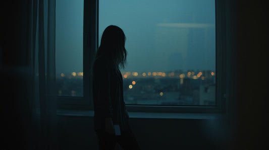 woman standing by a window doubting her relationship