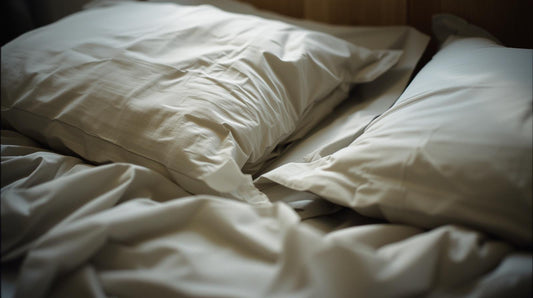 Rumpled bedsheets in morning light symbolizing post-breakup intimacy and emotional ambiguity