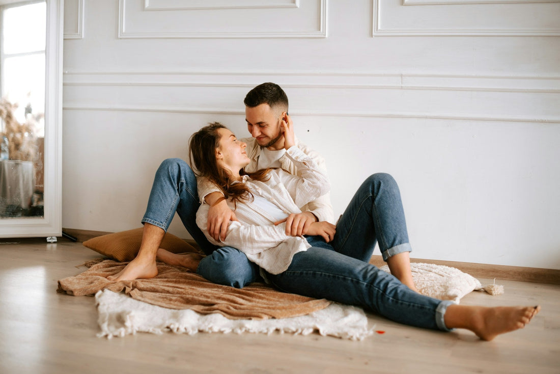 Affectionate couple sitting closely together, representing falling in love in a situationship despite uncertain commitment`