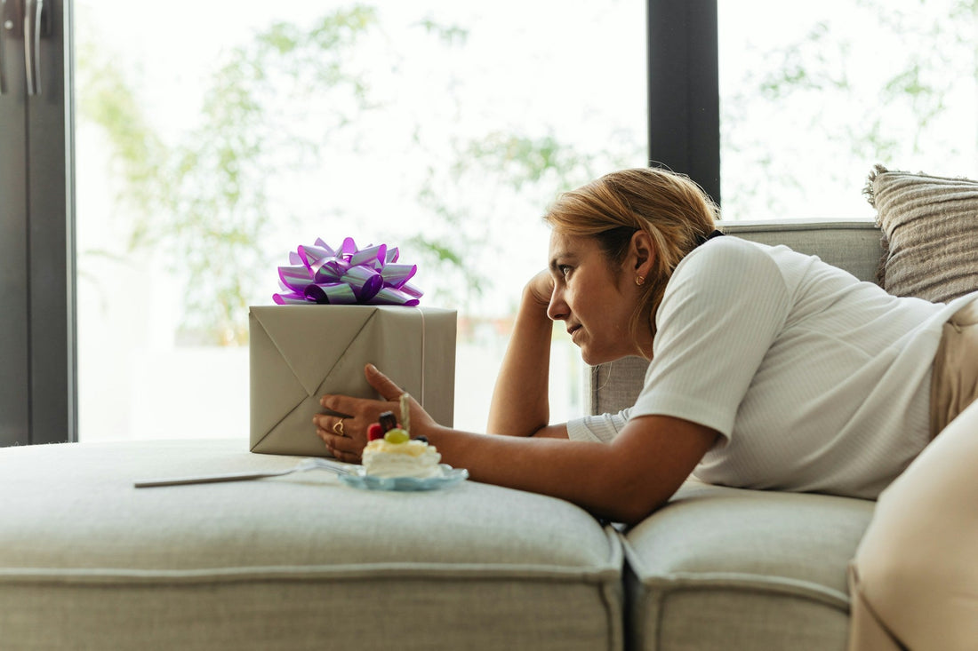 woman with I miss you gif on sofa looking very happy.