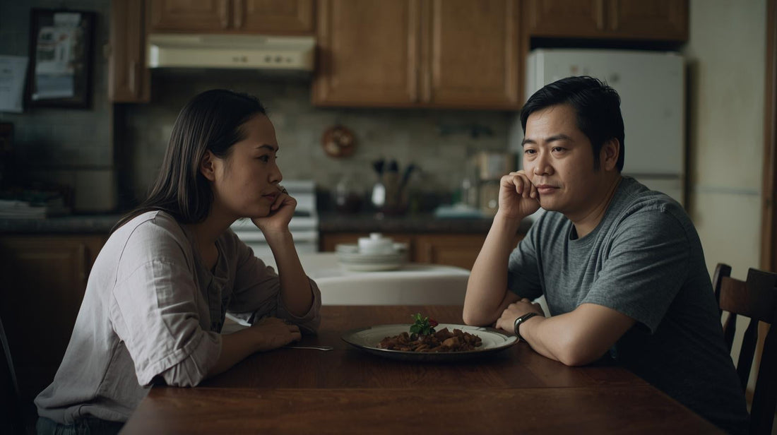 Couple sitting quietly at a table considering whether their relationship can be saved