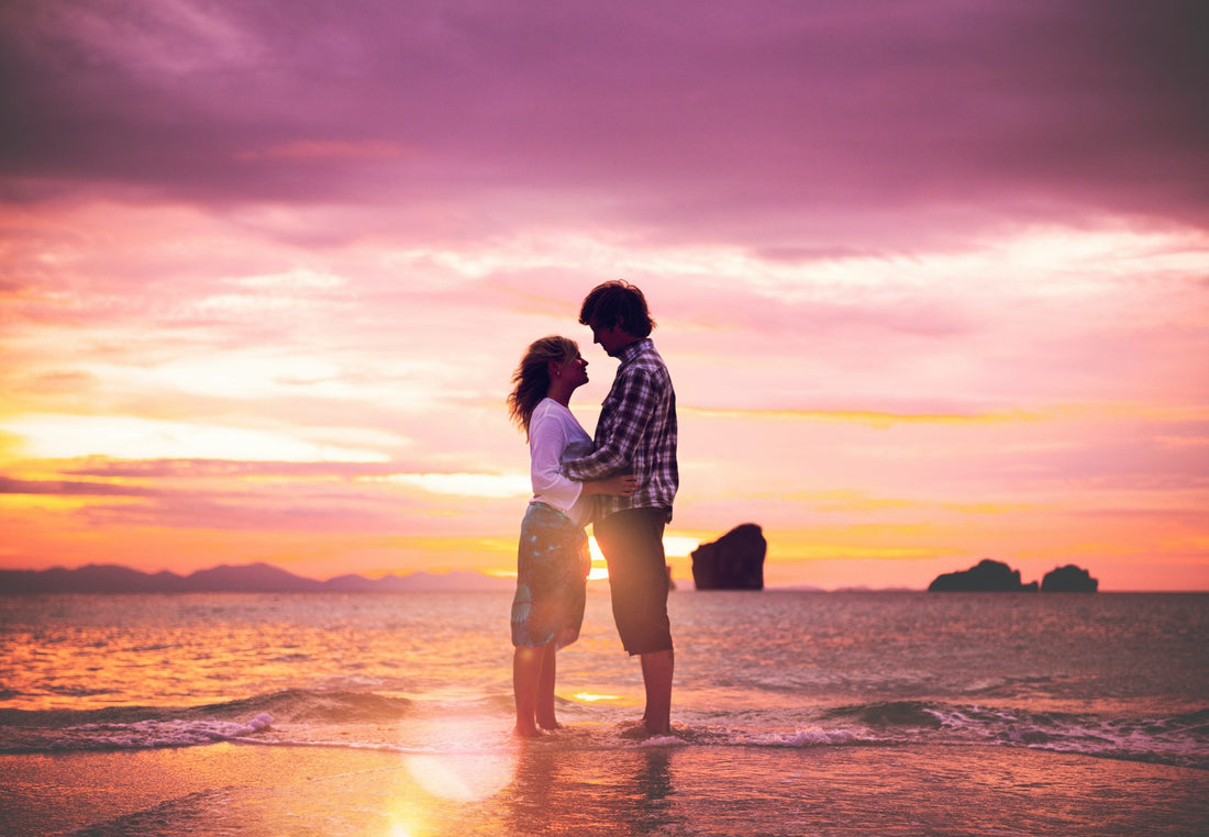 Romantic couple embracing on a beach at sunset, representing the idea of meeting a future soulmate.