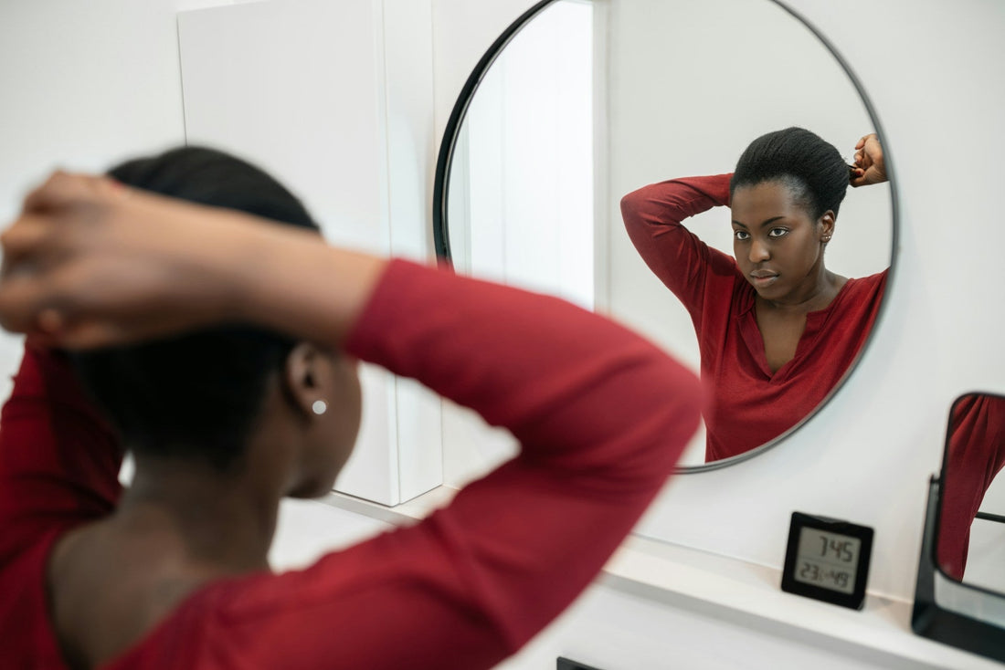 Woman getting ready in front of a mirror before dating again after a breakup or divorce, representing confidence, fresh starts and returning to dating.