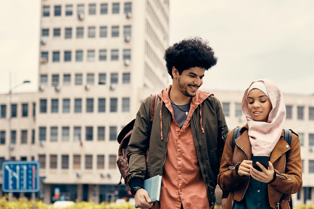 Muslim man and woman walking together while discussing different levels of religiosity and expectations before marriage.