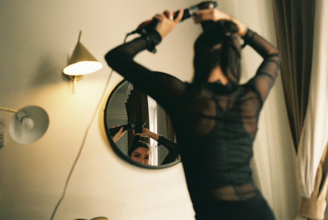 Woman looking at her reflection while getting ready, symbolising the question of whether she misses her ex or the version of herself she felt in the relationship