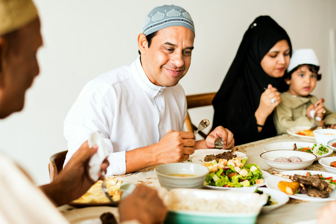 Muslim family sharing a meal together, representing family involvement, support and boundaries in Muslim marriage decisions.