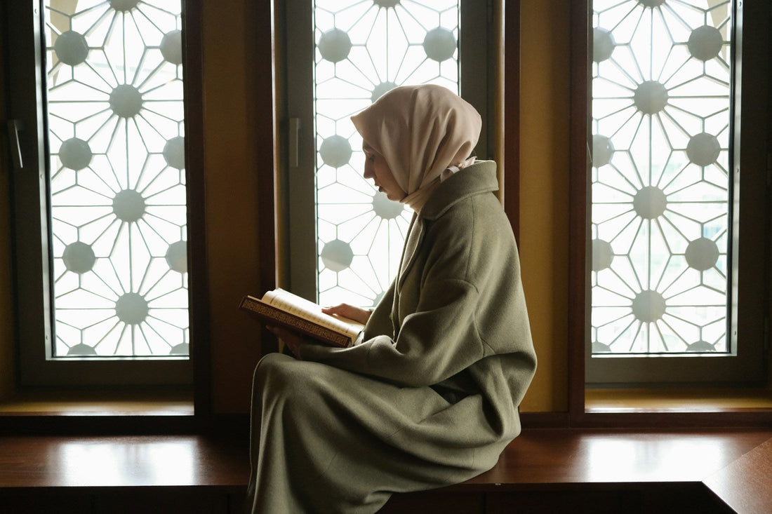 Muslim woman reading the Quran alone while finding faith, hope and reassurance about meeting a future Muslim partner.