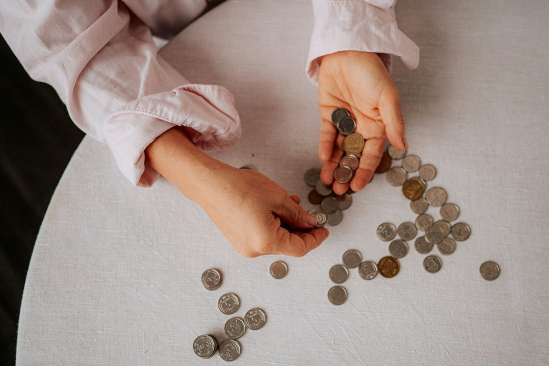 Person counting a small amount of money, symbolizing financial restriction, dependency, and limited access to shared funds in a marriage.