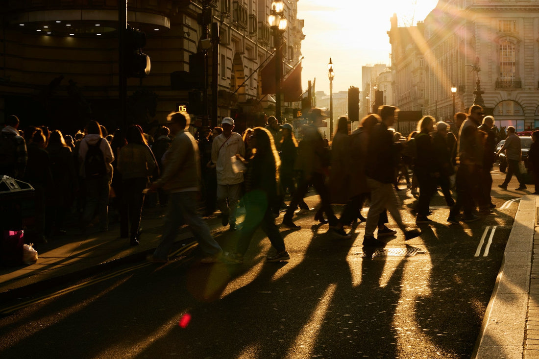 Crowded city street at sunset, symbolising the public visibility and social pressure of a gay breakup.