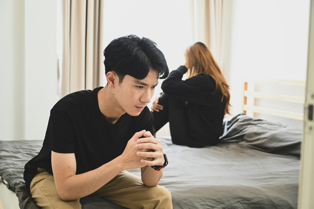 couple sitting back to back on bed symbolizing they have outgrown their relationship