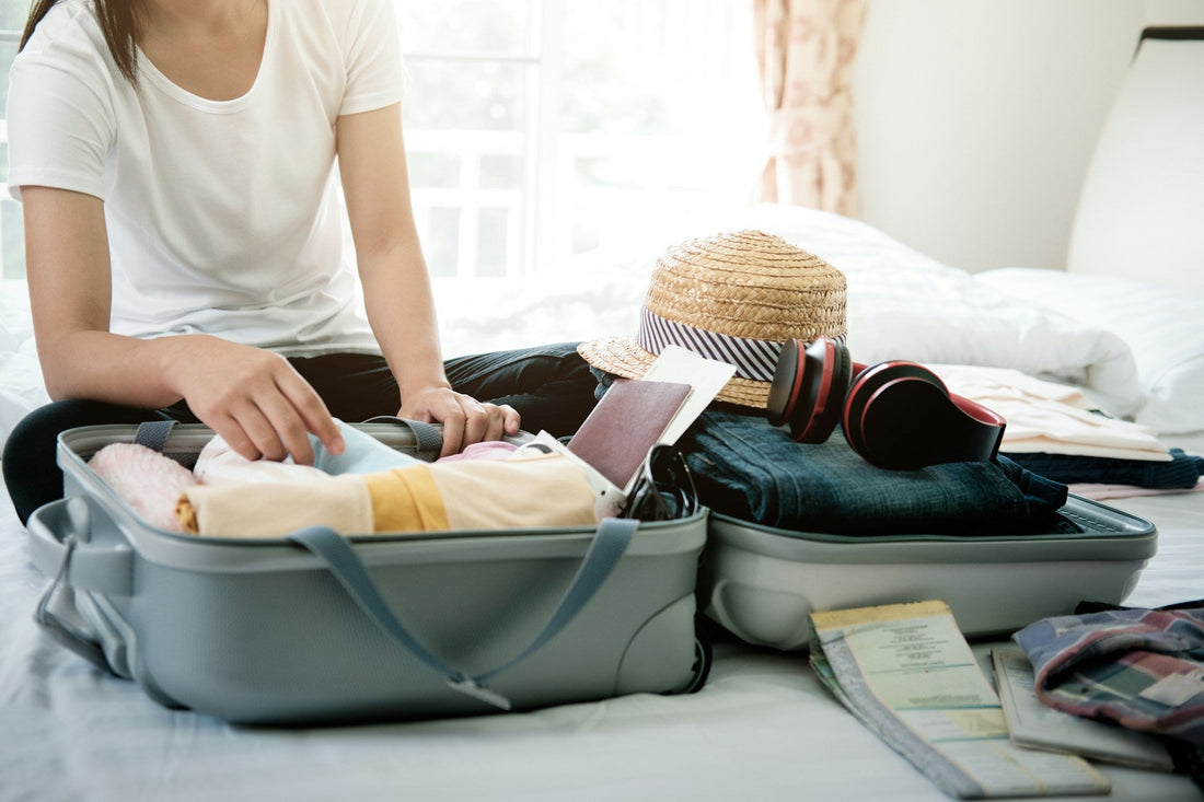 Woman packing a suitcase on a bed, symbolizing guilt, uncertainty, and preparing to leave a narcissistic spouse.