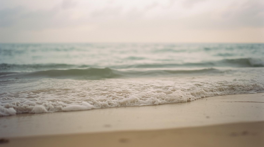 Gentle ocean waves under soft light symbolizing uneven emotional healing
