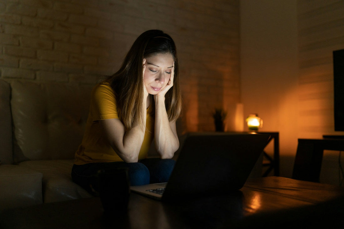 Woman looking worried at her laptop while questioning whether her long-distance relationship is still working