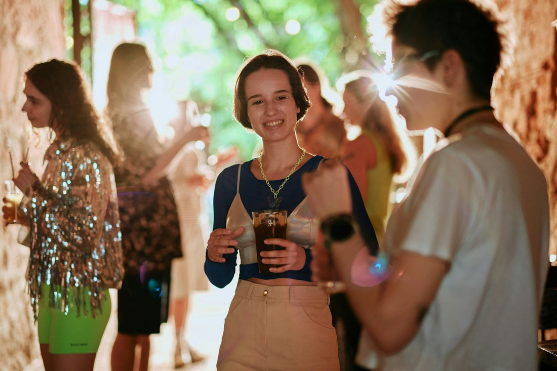 Two people talking at a social event after a breakup, illustrating how to stay calm and composed around an ex who dumped you.