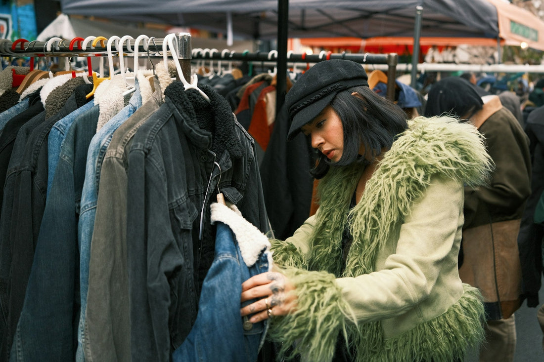 A woman looking at clothes on a rack looking to change her style after a breakup