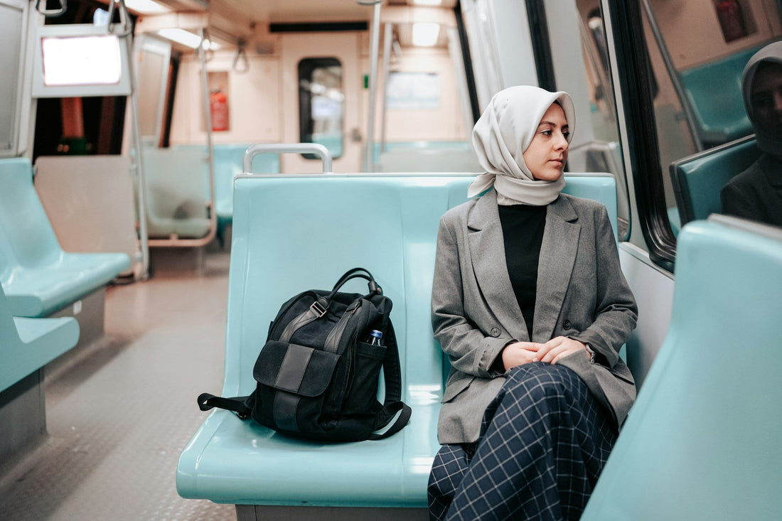 Muslim woman sitting alone on a train and looking out the window while learning to let go of someone she cannot marry.