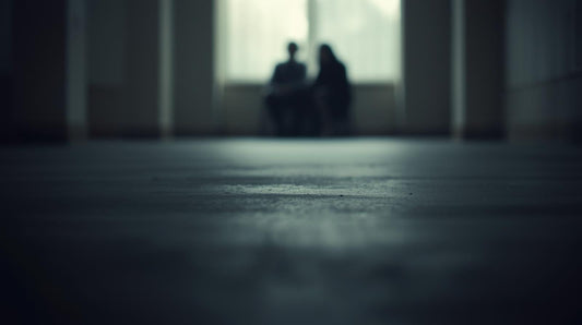 Distant blurred figures sitting close together representing imagined scenes after a breakup