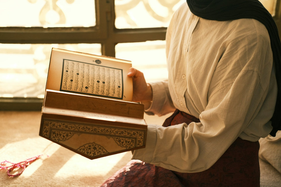 Muslim woman reading the Quran in warm light while seeking spiritual guidance after istikhara gives no clear answer.
