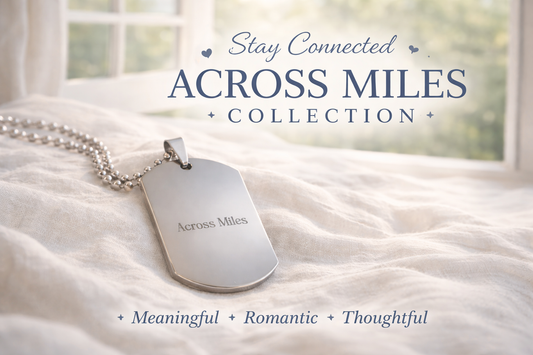 Across Miles dog tag necklace on soft linen near window promoting Left Unsaid long distance relationship collection