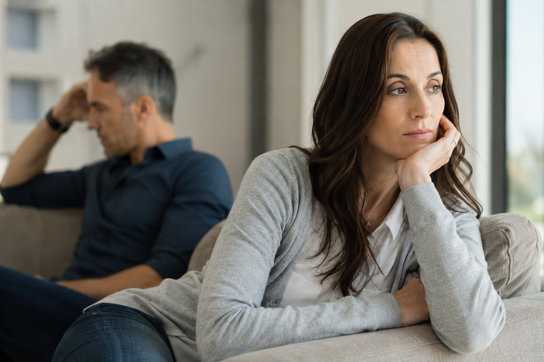 Woman sitting apart from her husband at home, reflecting emotional distance in a narcissistic marriage.