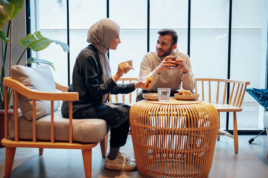 Muslim couple having a relaxed conversation over food while discussing marriage compatibility and life before nikah.