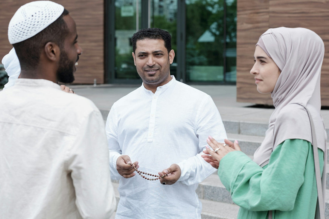 Muslim woman and two Muslim men having a thoughtful conversation about faith, relationships and marriage compatibility.
