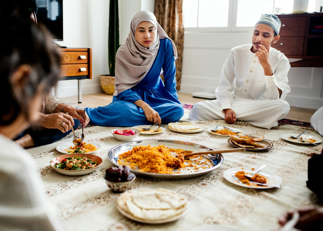 Muslim couple sitting with family during a serious discussion about parental concerns and marriage approval.