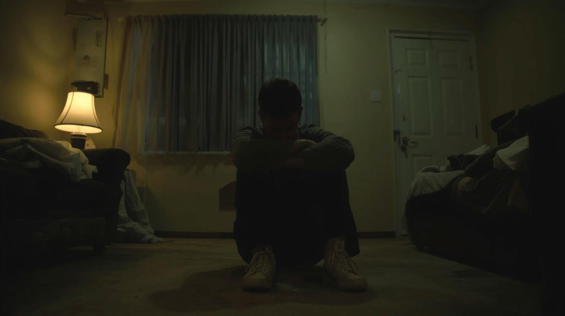 Man sitting alone in a dim room after emotional confrontation representing narcissistic collapse