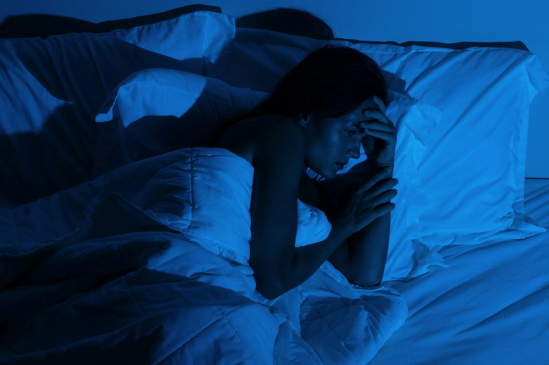 Person lying awake at night with intrusive thoughts, illustrating relationship anxiety and OCD in romantic relationships.