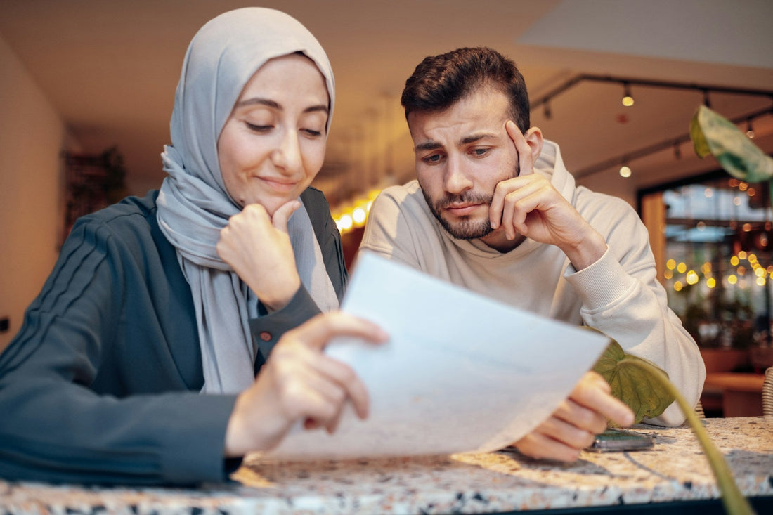 Muslim couple reviewing a document together while discussing important questions and compatibility before marriage.