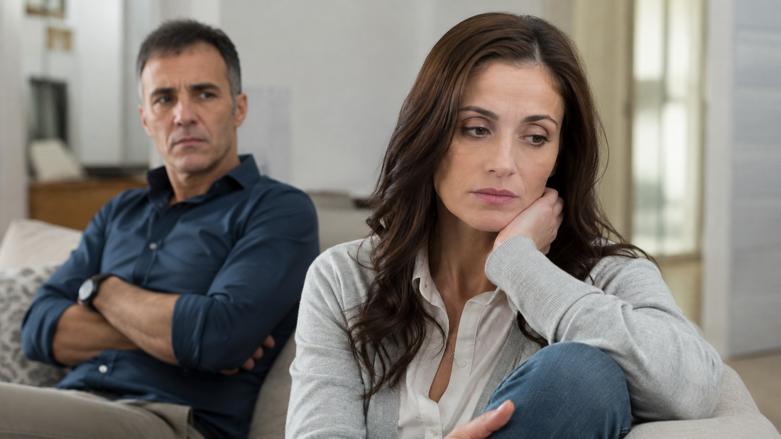 Woman looking withdrawn while her husband watches from behind, reflecting tension and emotional distance in a narcissistic marriage.