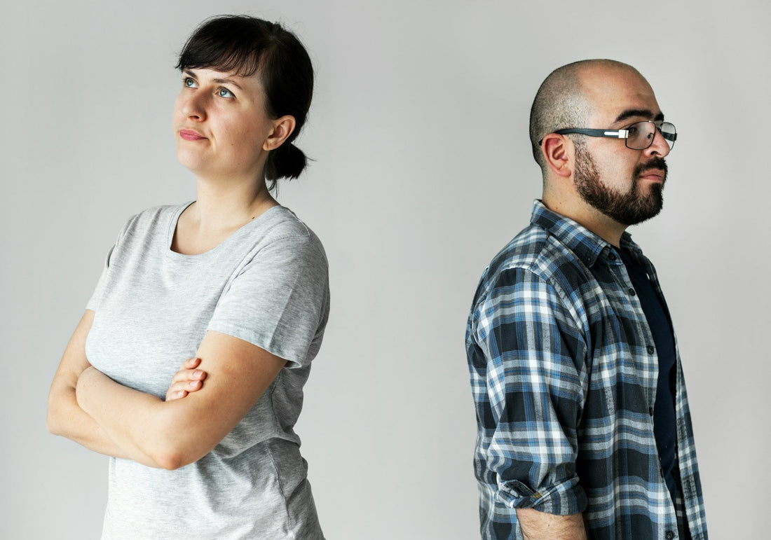 **SEO alt text:** `Couple standing back to back and looking in opposite directions, representing uncertainty and emotional distance in a situationship`