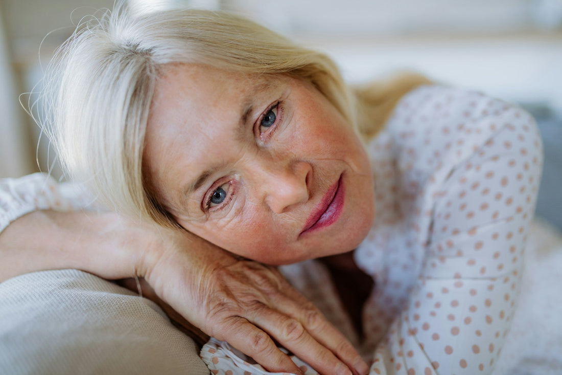 Mature woman resting thoughtfully as vaginal dryness, menopause symptoms, and sexual discomfort affect intimacy