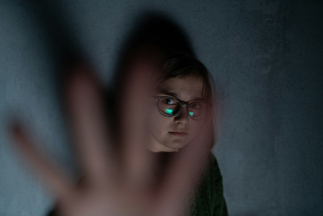 Woman calmly raising her hand while setting a clear boundary during a difficult relationship conversation