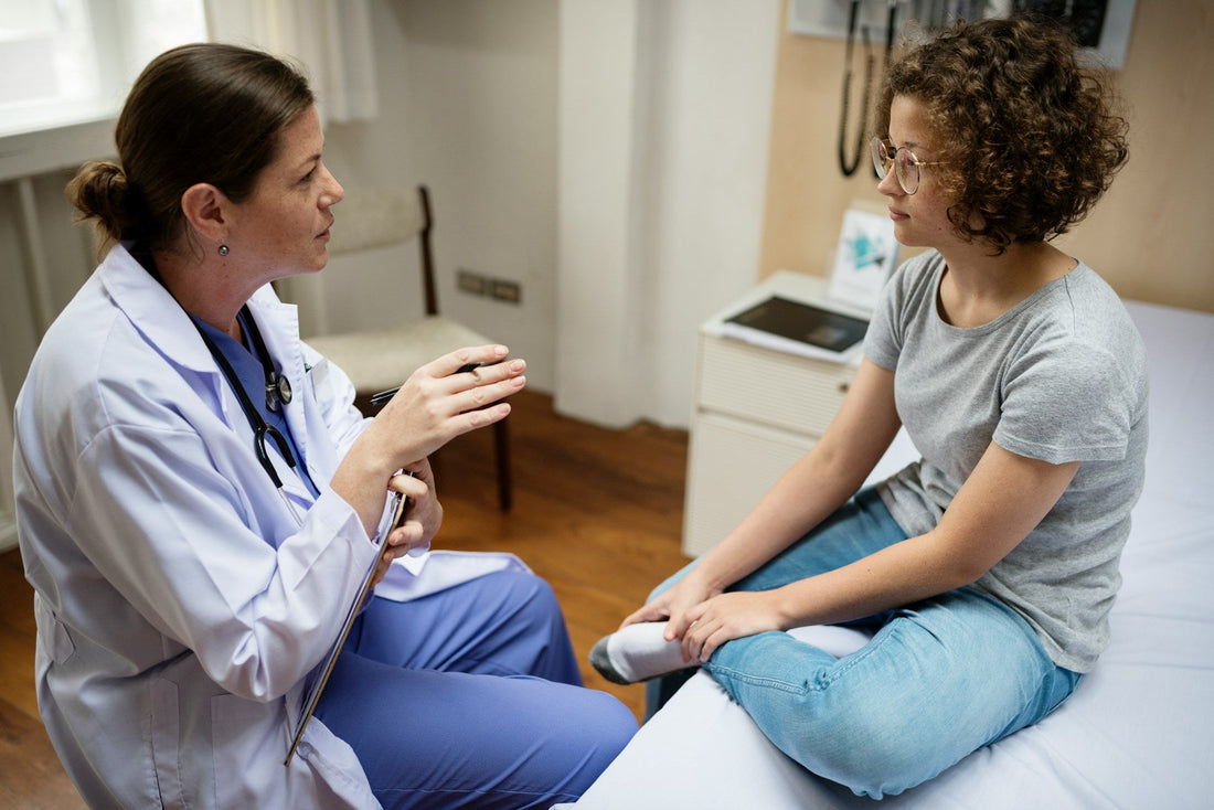 Woman discussing persistent low libido and possible medical causes with a healthcare professional during a sexual health appointment