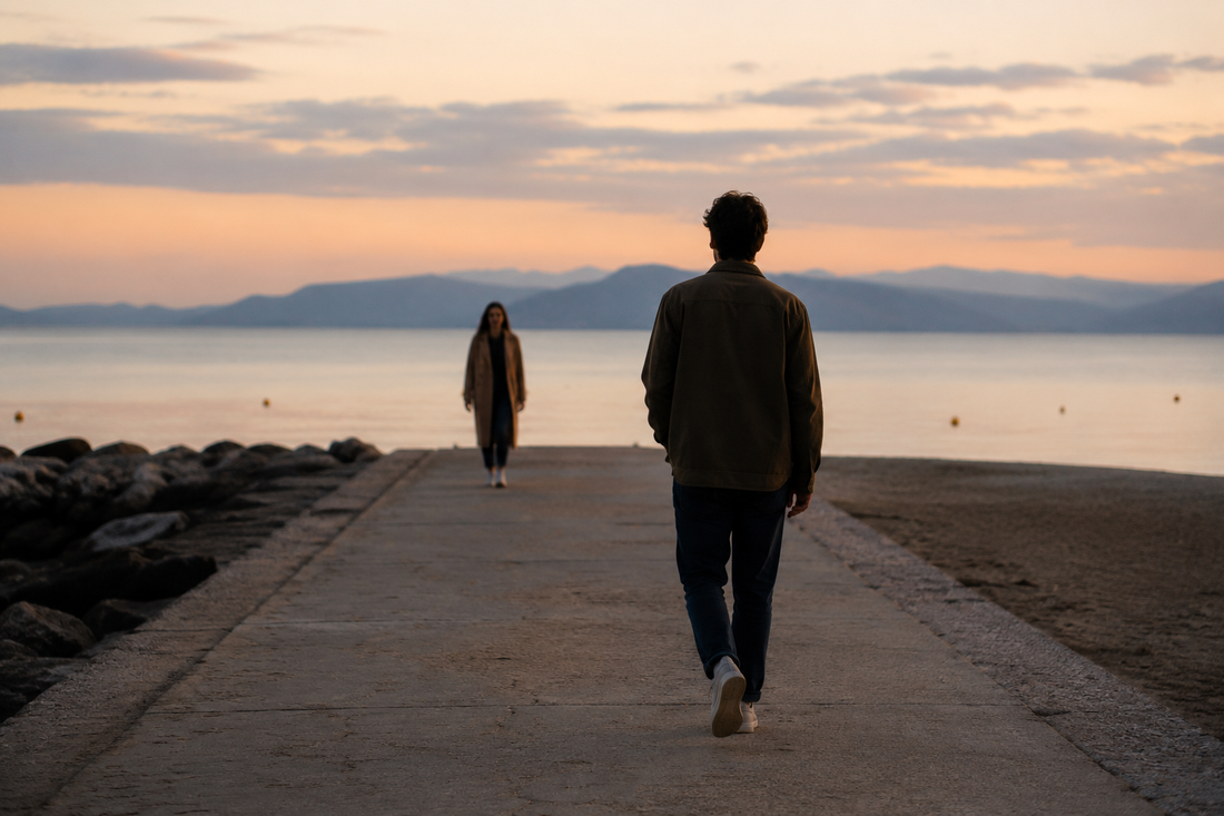 Two people walking toward each other by the water, suggesting reconnection after emotional distance.