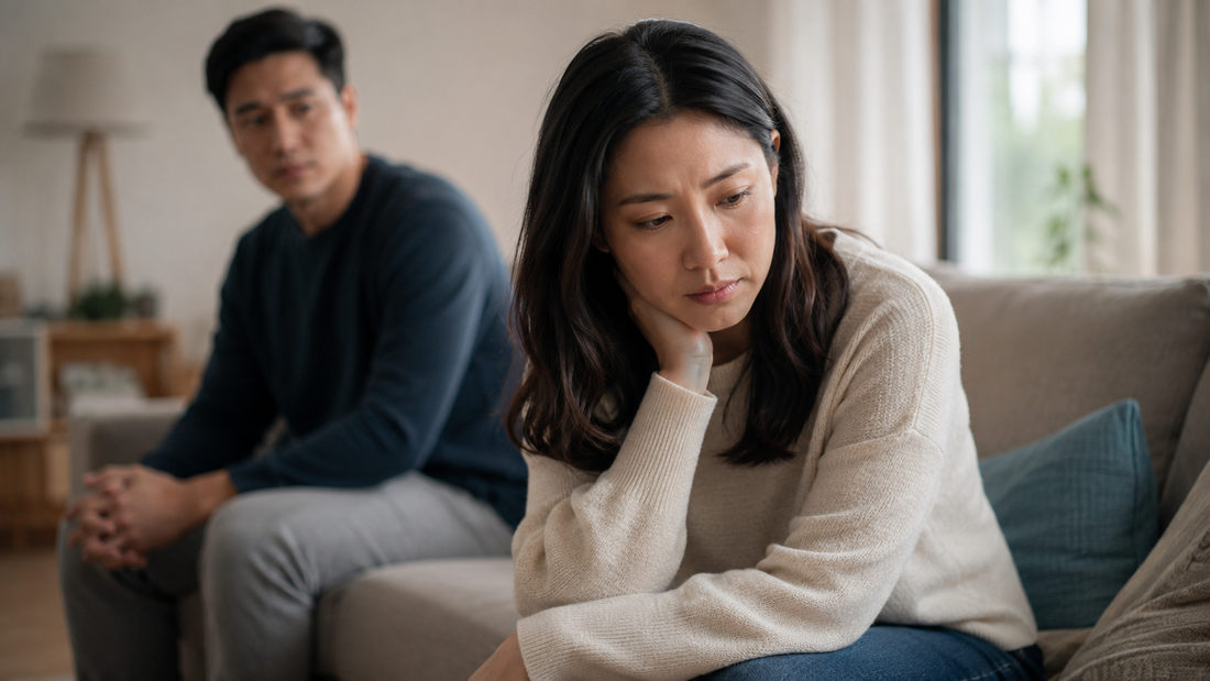 Couple sitting apart after an argument, representing stonewalling versus needing space in a relationship