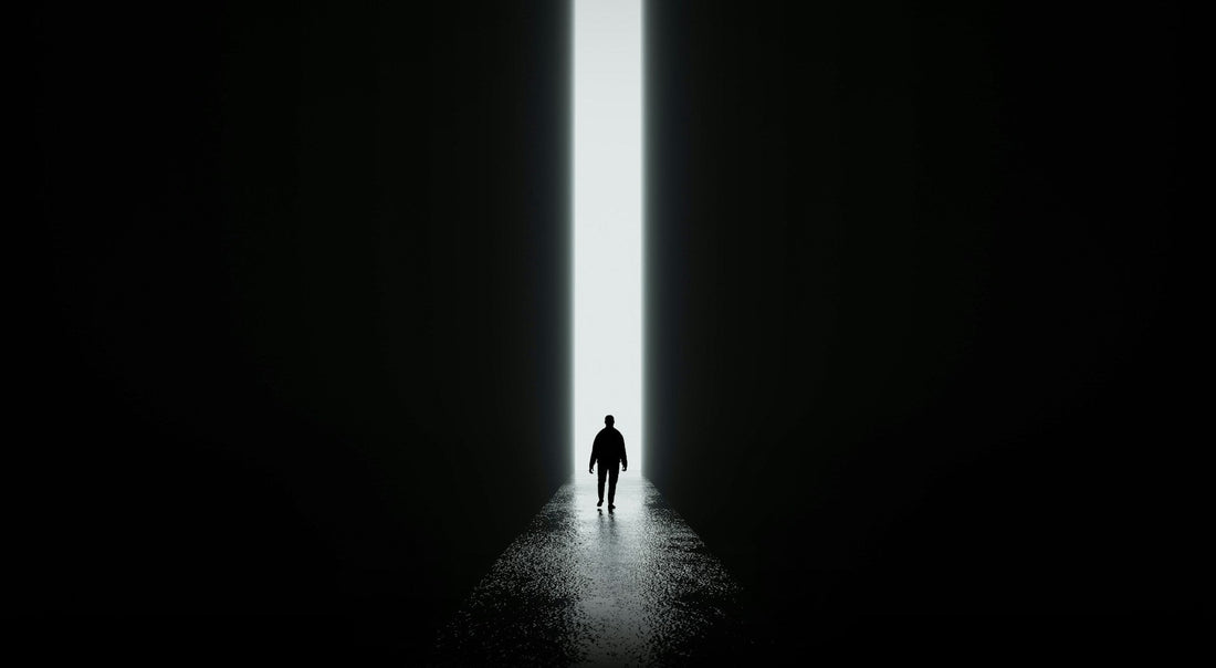 Silhouette of a person walking toward light, symbolising emotional recovery and feeling like you are starting over after a breakup