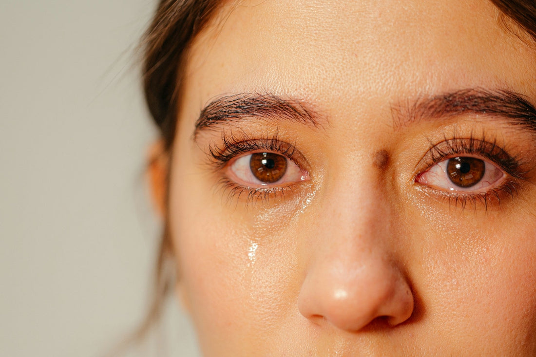Tearful woman experiencing a sudden wave of breakup grief that makes the loss feel new again