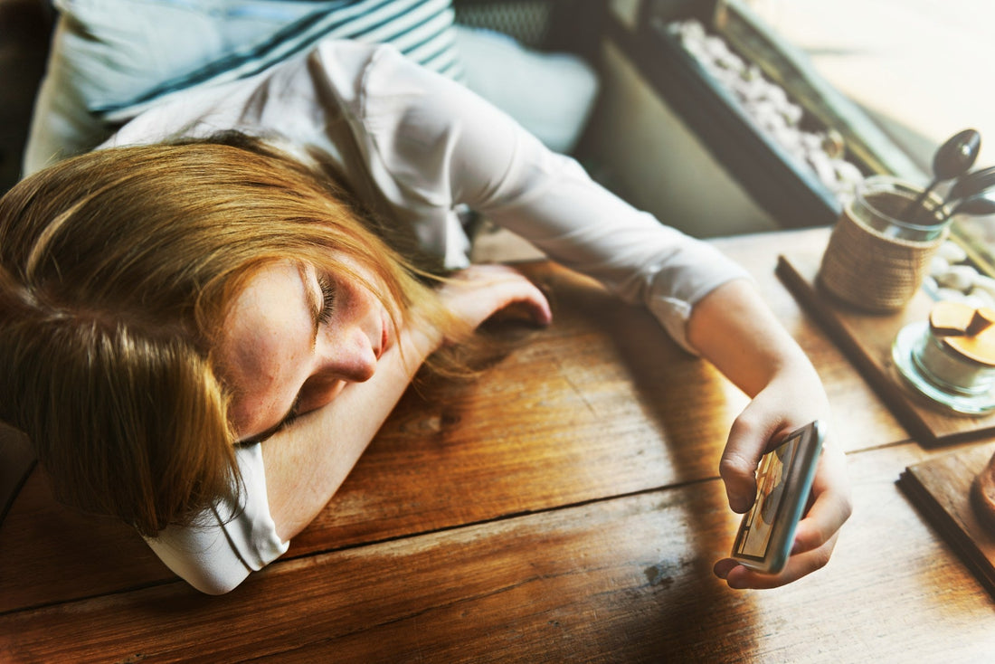 Woman lying by her phone feeling disconnected as her long-distance relationship starts to feel different