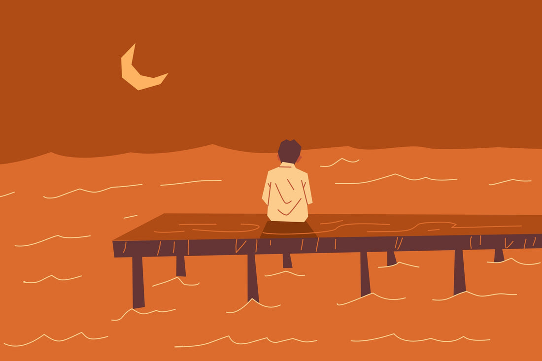person sittion on a pier looking at the waves that symbolizes why missing someone comes in waves