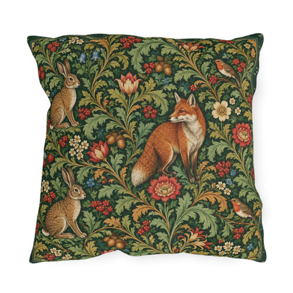 A square decorative throw pillow featuring a detailed vintage-style woodland pattern with a fox, rabbits, birds, and flowers on a dark green background.